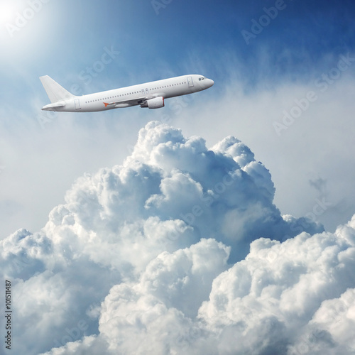 Fototapeta Naklejka Na Ścianę i Meble -  Plane flying through dramatic storm clouds
