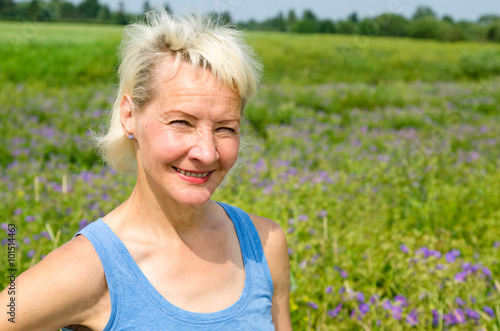 Portrait of a woman amid the summer meadows in the countryside