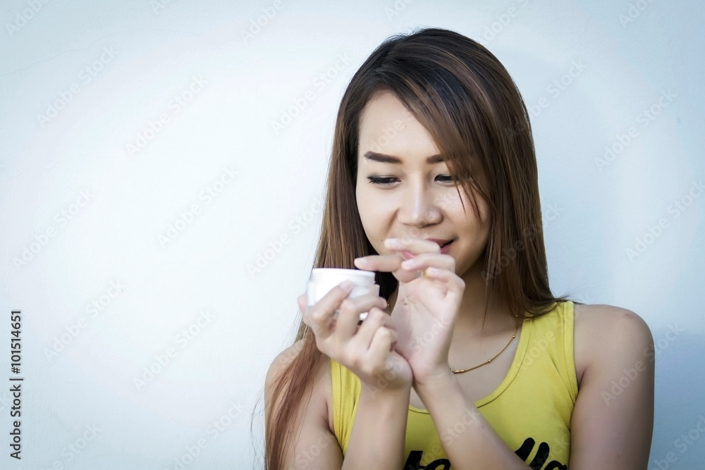 A beautiful woman asia using a skin care product, moisturizer or lotion and Skincare taking care of her dry complexion. Moisturizing cream in female hands A beautiful woman asia using a skin care product, moisturizer or lotion and Skincare taking care of her dry complexion. Moisturizing cream in female hands