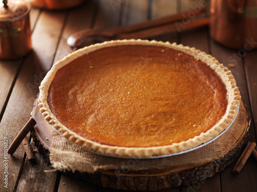 large pumpkin pie in rustic setting photo