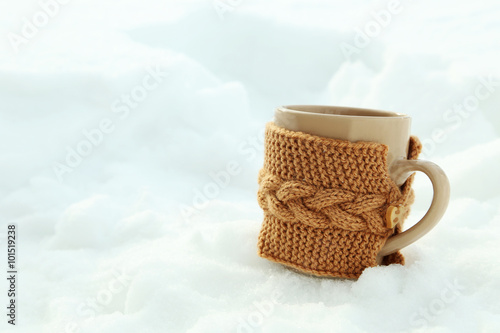 Beige cup on the white snow photo