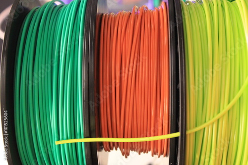 Three multi-color 3d printing filament spools photo