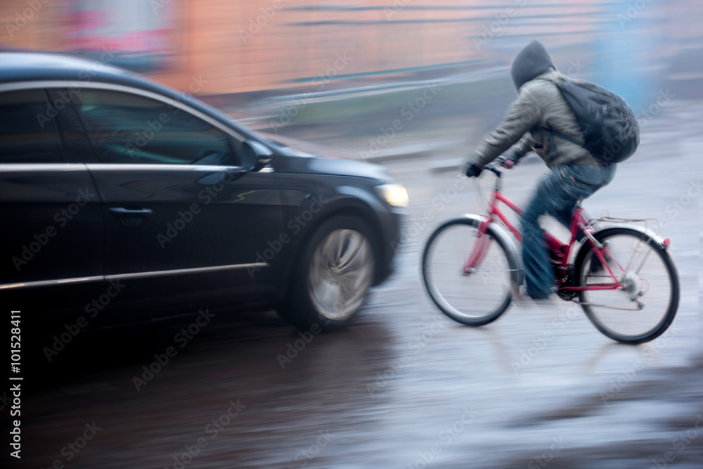 Dangerous city traffic situation with cyclist and car