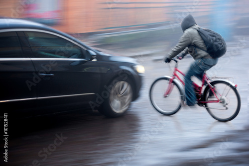 Dangerous city traffic situation with cyclist and car