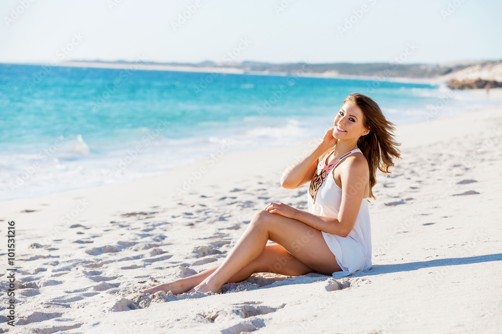 Young woman sitting on the beach