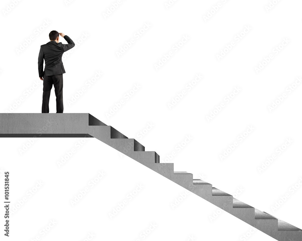 Businessman gazing on top of concrete stairs Businessman gazing on top of concrete stairs