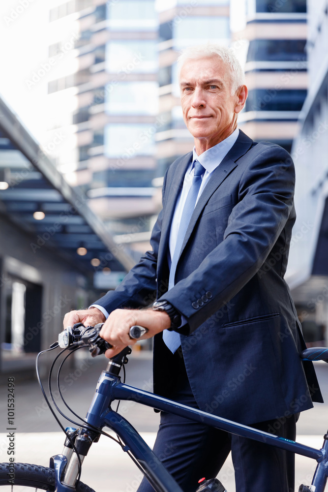 Successful businessman riding bicycle