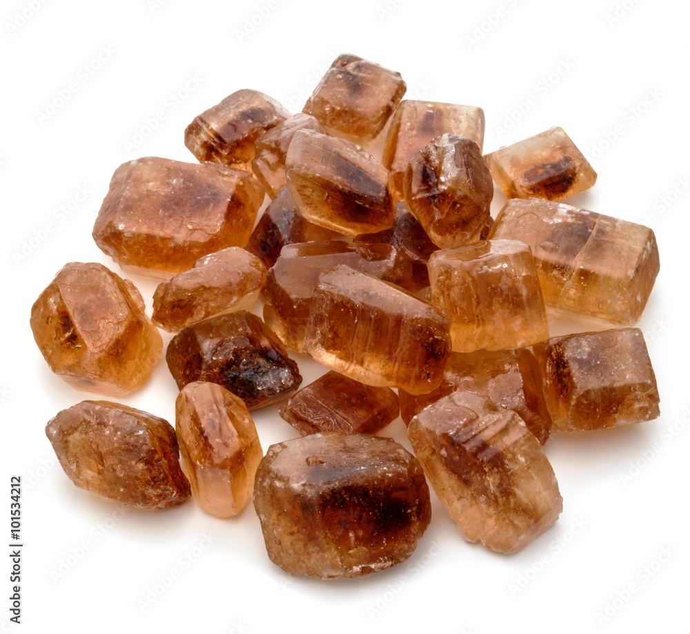 Brown caramelized lump cane sugar cube isolated on white backgro Brown caramelized lump cane sugar cube isolated on white backgro