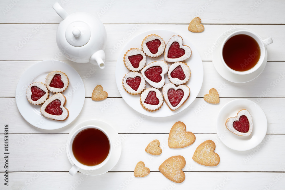 Φωτογραφία Sweet heart cookies for Valentines day with teapot and two cups of tea compositi