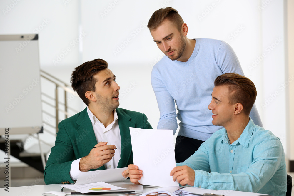Young business men at the meeting in a conference room Young business men at the meeting in a conference room