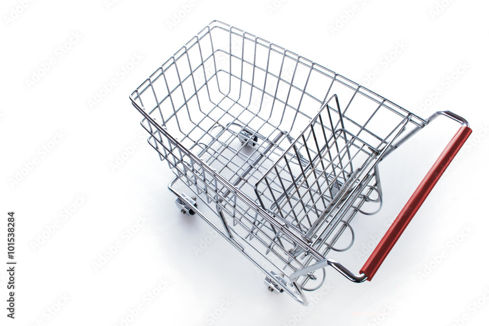 Einkaufswagen aus Metall mit rotem Griff vor hellem Hintergrund Einkaufswagen aus Metall mit rotem Griff vor hellem Hintergrund