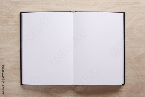 Open blank textbook on wooden background
