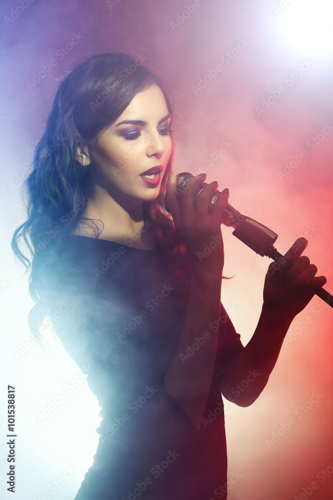 Beautiful singing woman on red background in the smoke, close up Beautiful singing woman on red background in the smoke, close up