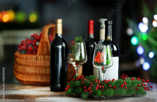 Wine in basket on blurred Christmas tree background