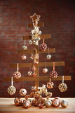 A handmade Christmas tree and baubles on wall background