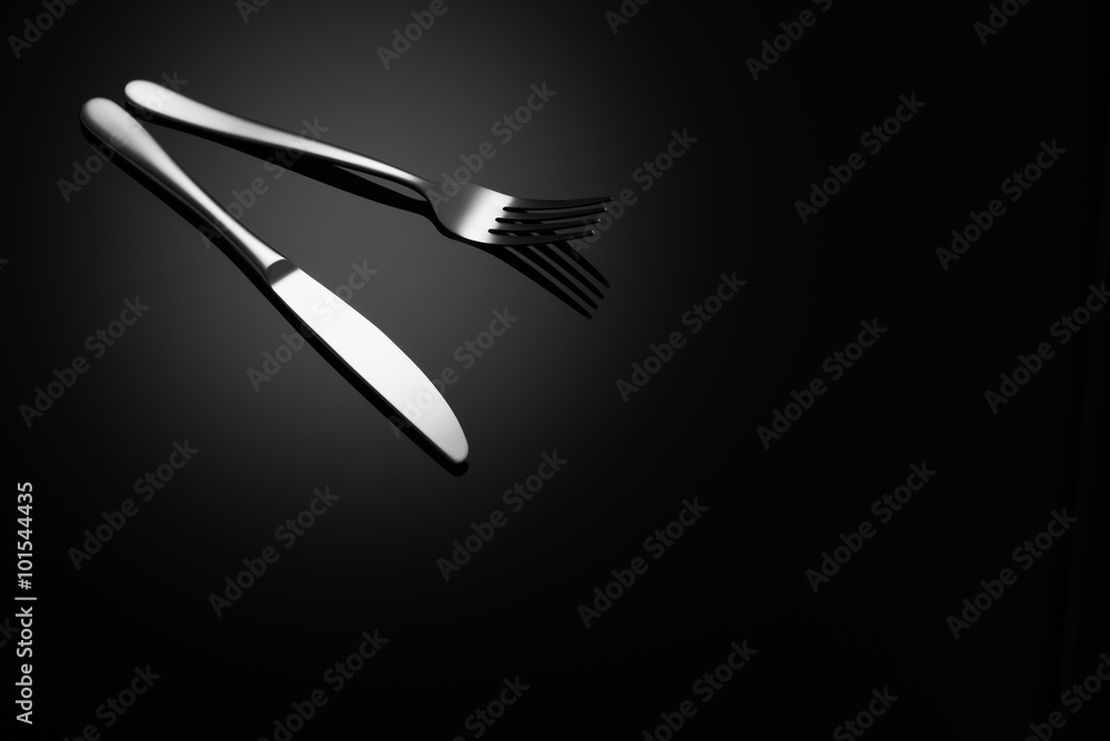Stainless steel, modern silverware on black background with reflection. Stainless steel, modern silverware on black background with reflection.