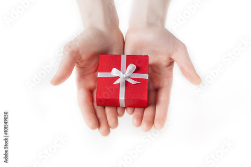 Hand holding box for a gift isolated on white 