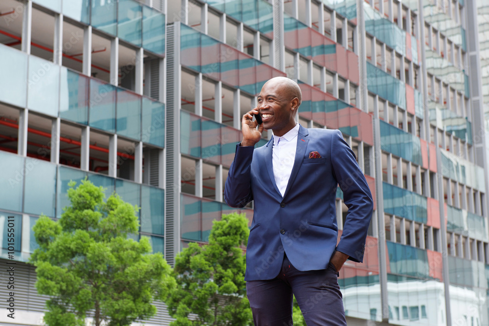 African businessman talking on mobile phone in the city street African businessman talking on mobile phone in the city street