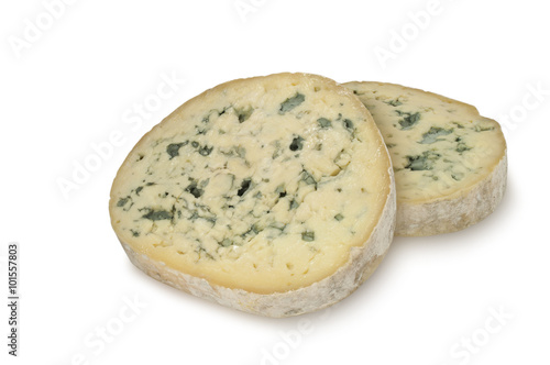 Two round piece of blue cheese (Fourme d'Ambert) isolated on white background