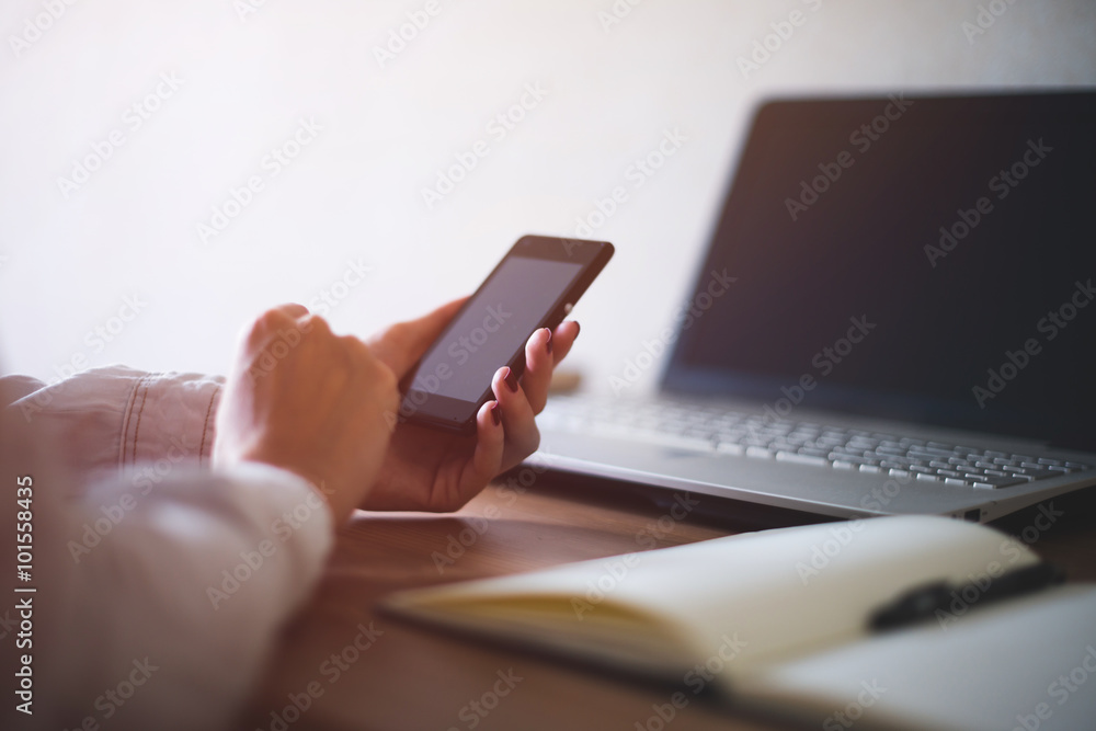 Woman using mobile phone in office workplace Woman using mobile phone in office workplace