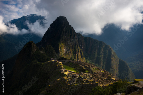 First sunlight on Machu Picchu from opening clouds