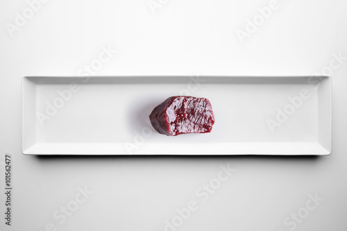 Raw luxiry whale meat isolated on white plate photo