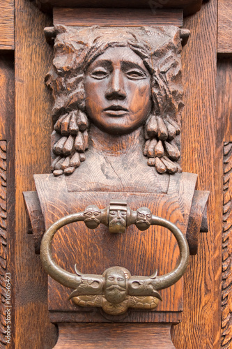 Vintage door handle with a bas-relief depicting the full-face woman