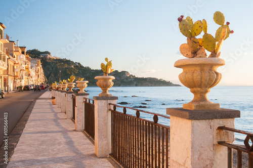 View of an ornamental vase with a cactus plant along the seafront of the touristic village Giardini Naxos, Eastsicily