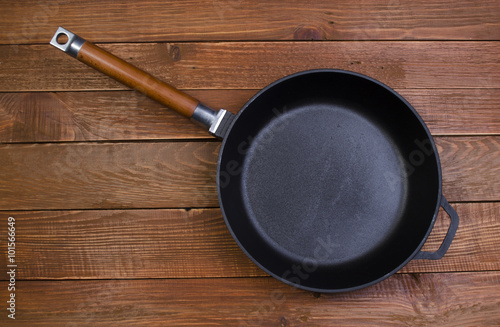 black frying pan on a wooden background