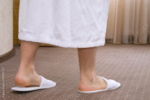 Young man legs with white slippers