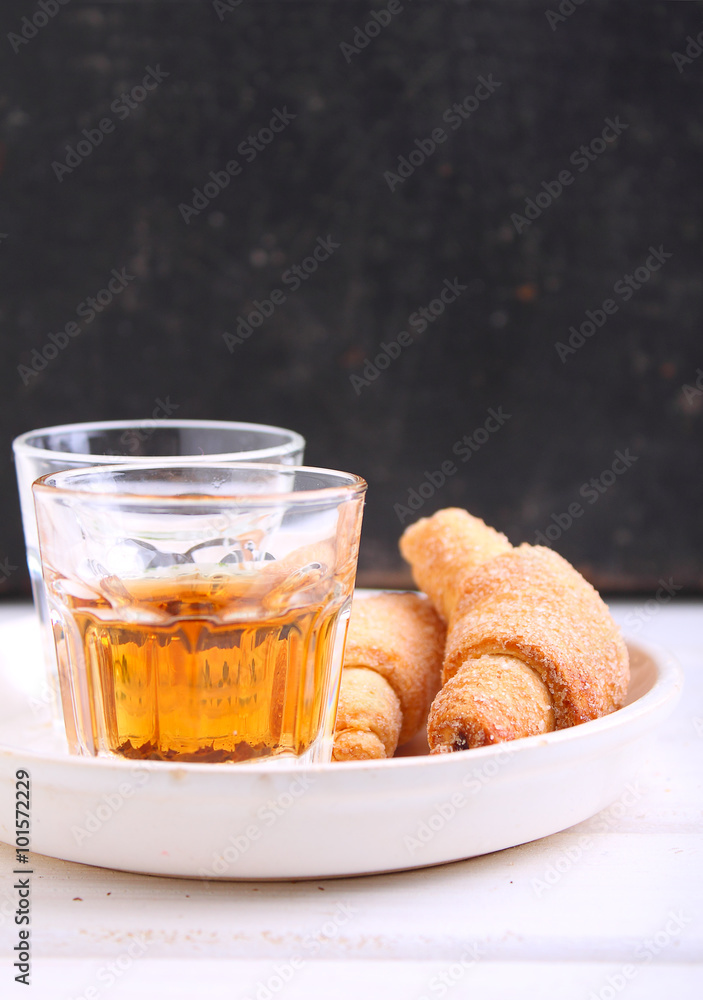 bagel with jam and tea in a glass on a white tray bagel with jam and tea in a glass on a white tray