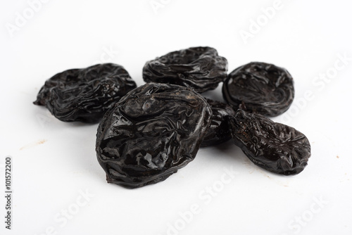 Dried plums prunes on white background
