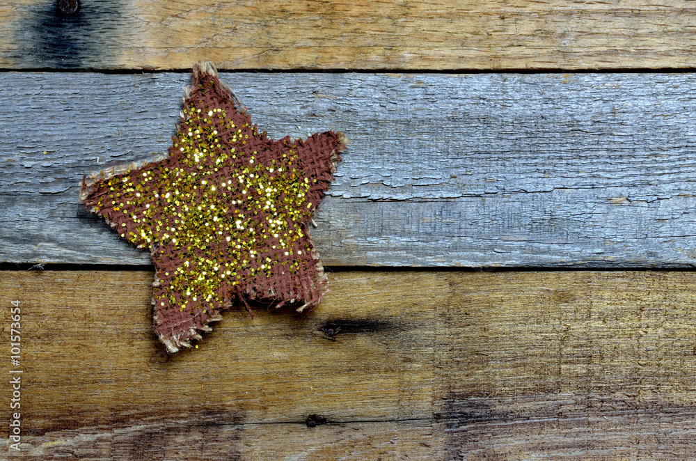 Homemade painted mesh star with glitter, set on pallet wood background Homemade painted mesh star with glitter, set on pallet wood background