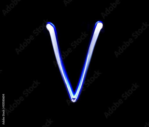 Quadro su tela V Victor alphabet hand writing blue light  over black background
