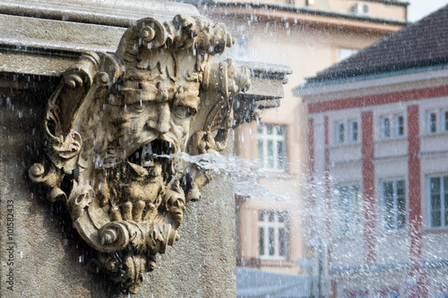 The bas-relief - a fountain with a picture of a man with a beard photo