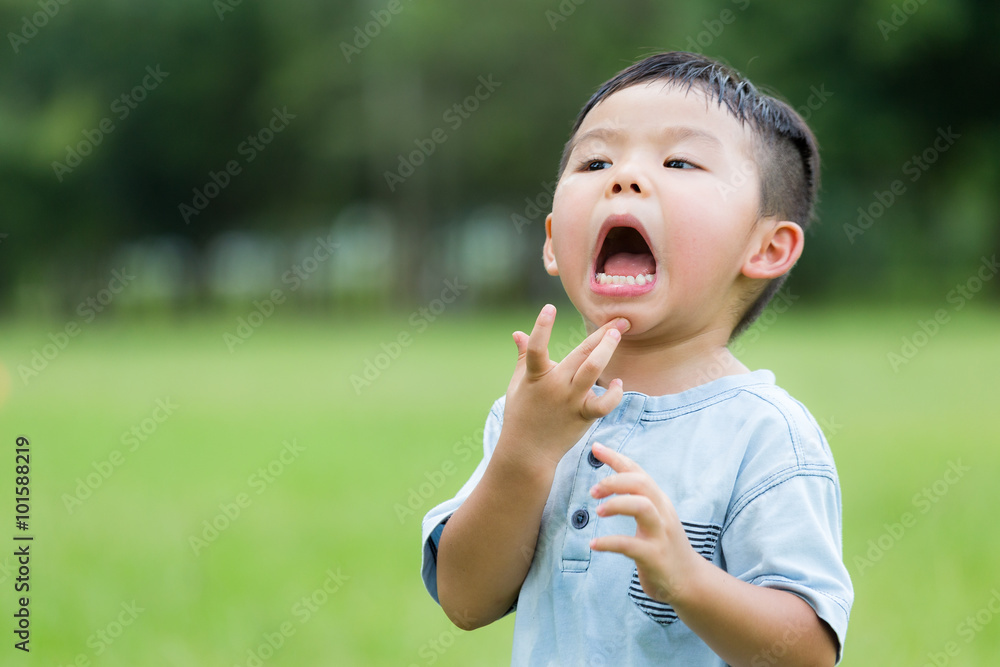 Young boy feeling itchy and scratching his face Young boy feeling itchy and scratching his face