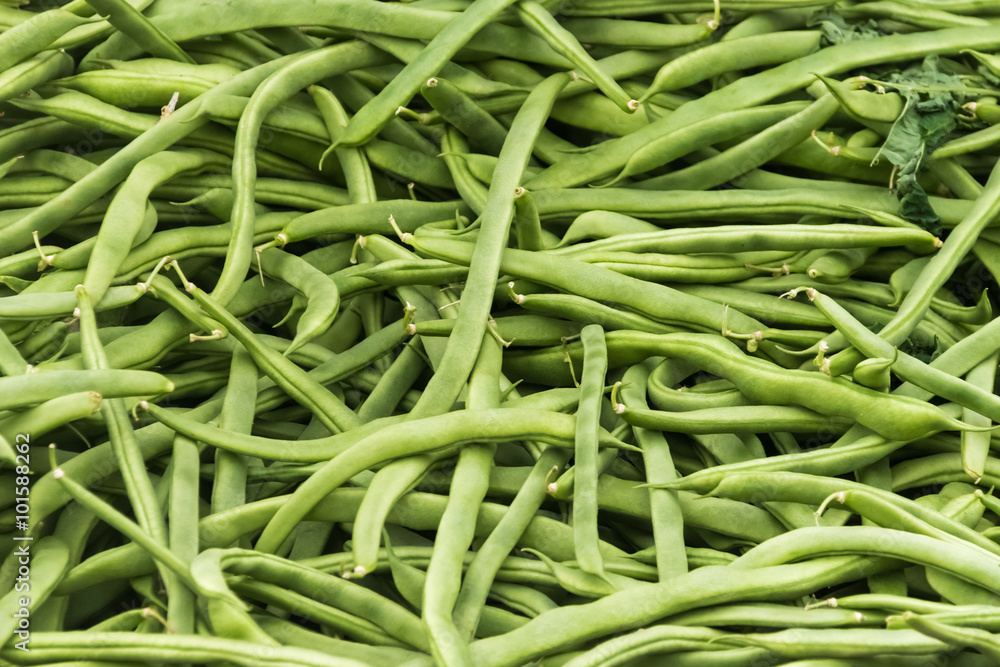 Pile of fresh green bean legumes at farmers market stall. Pile of fresh green bean legumes at farmers market stall.