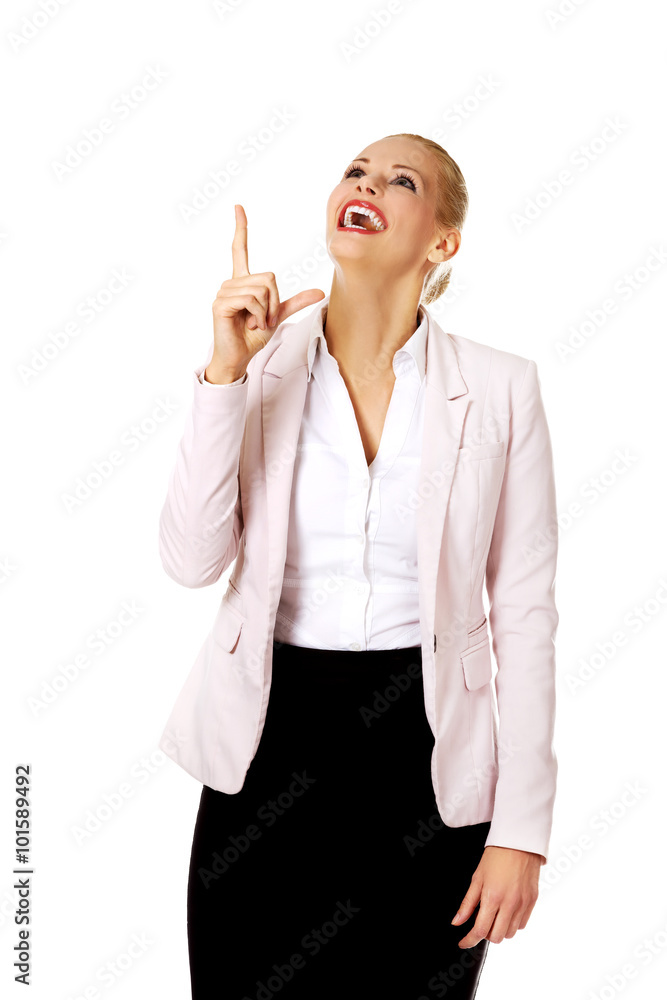 Young smiling business woman pointing up Young smiling business woman pointing up