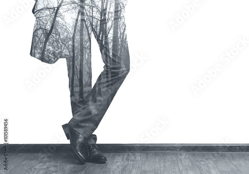 Businessman's legs and forest double exposure b/w image photo