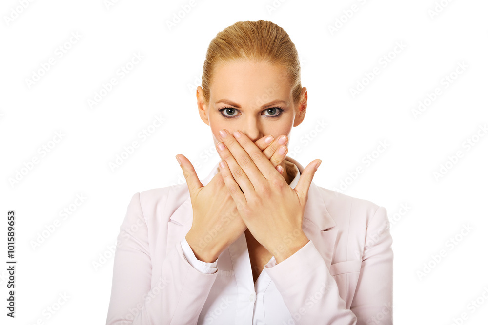 Young business woman covering her mouth with two hands Young business woman covering her mouth with two hands