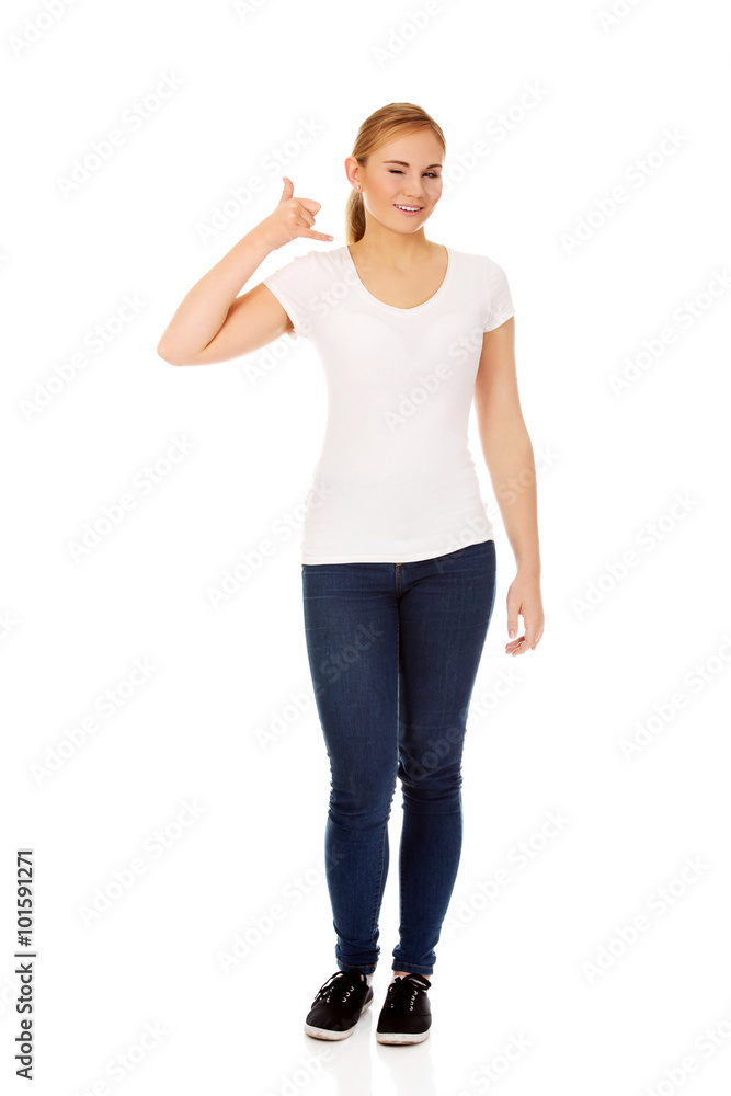 Young woman gesturing call me sign Young woman gesturing call me sign