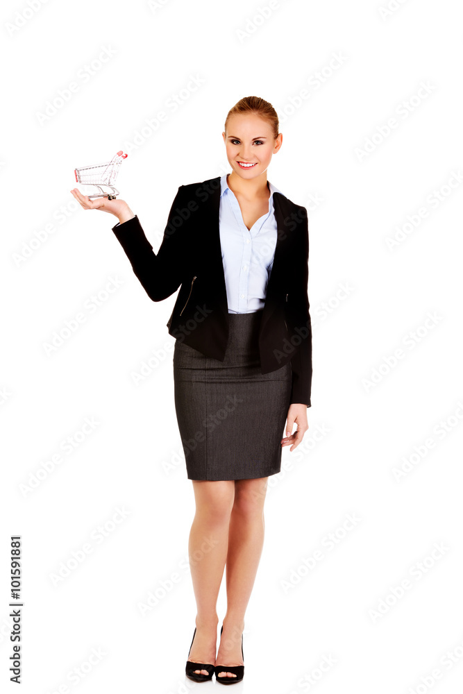 Attractive business woman holding small trolley Attractive business woman holding small trolley
