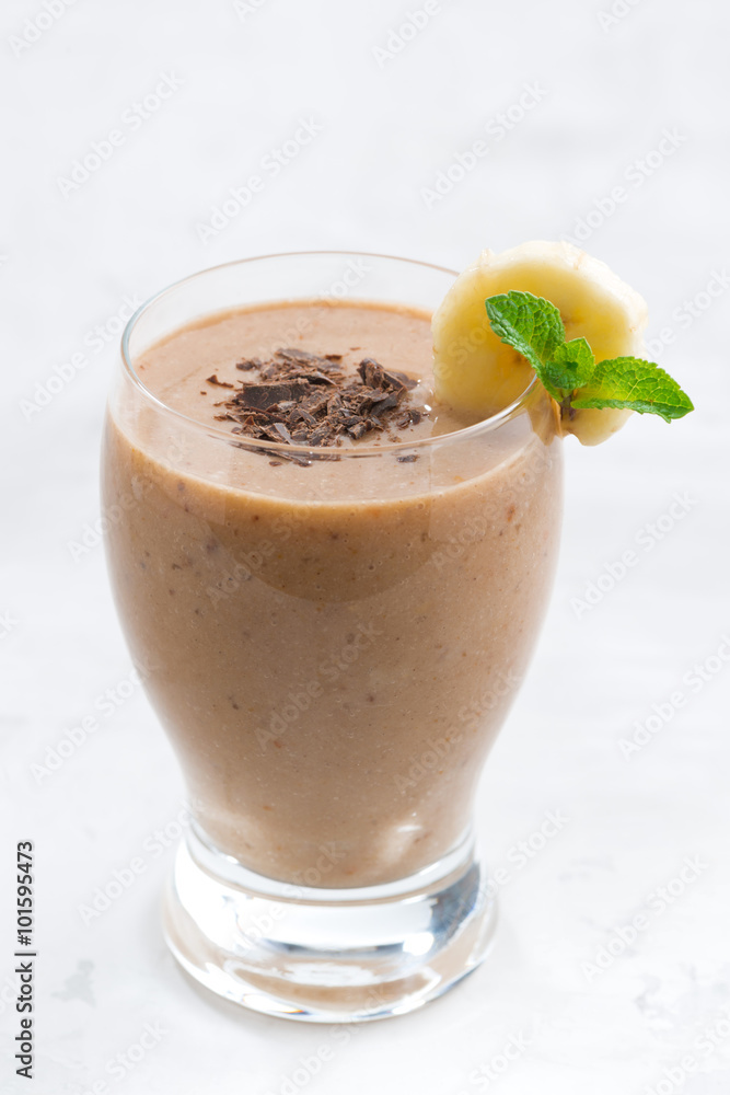 banana chocolate smoothie in a glass, vertical banana chocolate smoothie in a glass, vertical