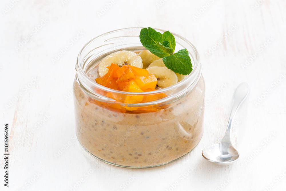 Banana dessert with persimmons in a glass jar Banana dessert with persimmons in a glass jar