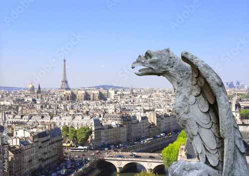 Gargoyle overlooking Paris up on Notre Dame de Paris, France © frenta