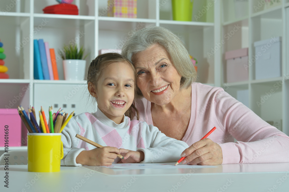 Grandmother with granddaughter drawing together Grandmother with granddaughter drawing together