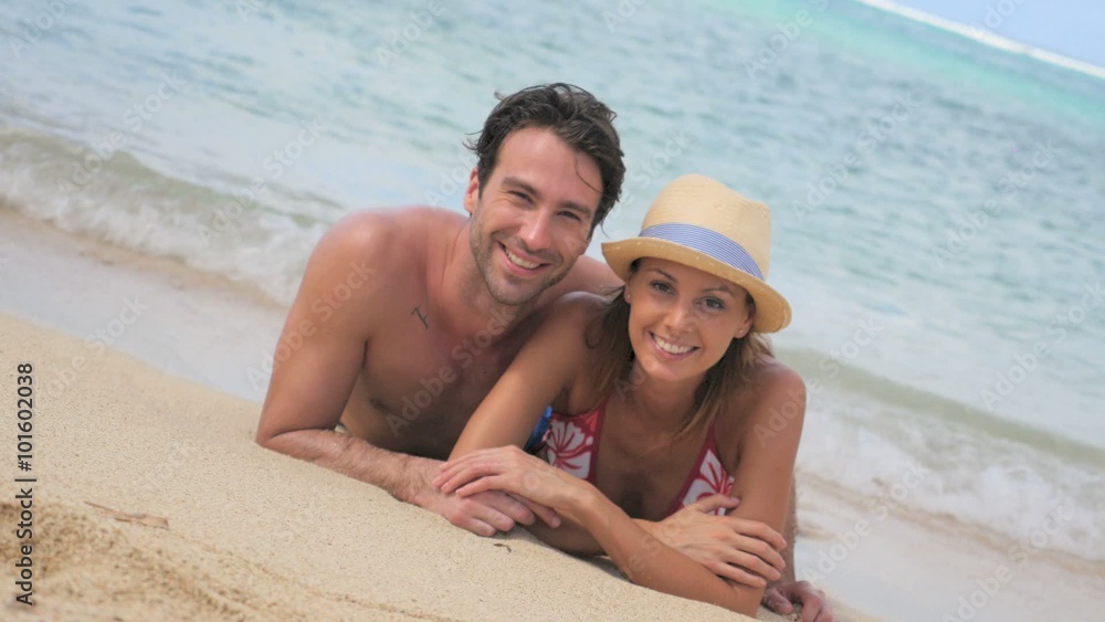 Couple relaxing on the beach in Caribbean island Couple relaxing on the beach in Caribbean island