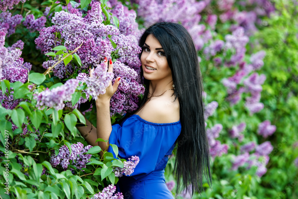 Beautiful smiling young woman with lilac flowers Beautiful smiling young woman with lilac flowers