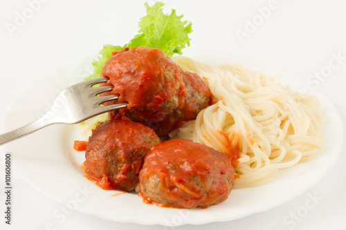 Pasta and meatballs with tomato sauce on the white background