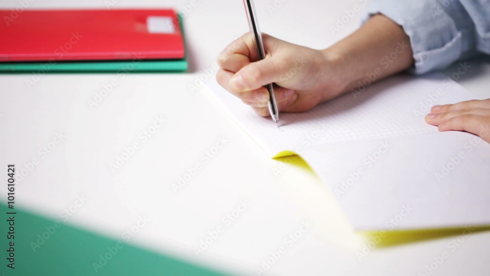 school girl writing math task to notepad school girl writing math task to notepad